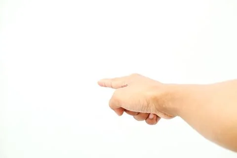 A human hand points toward the left side against plain white background dir.. Stock Photos