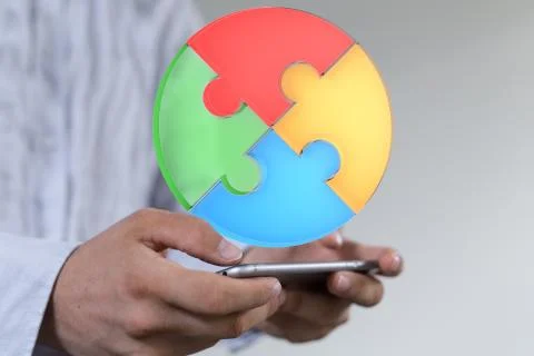 A human hand presenting the digital projection of a puzzle pie chart for a bu Stock Photos