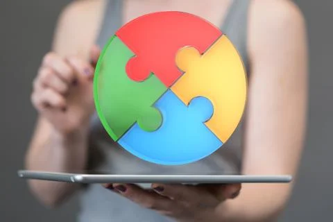 A human hand presenting the digital projection of a puzzle pie chart for a bu Stock Photos