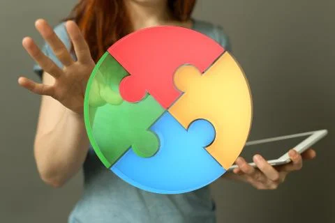 A human hand presenting the digital projection of a puzzle pie chart for a bu Stock Photos