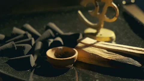 The human hand puts incense in the triangular stand Stock Footage 134828748