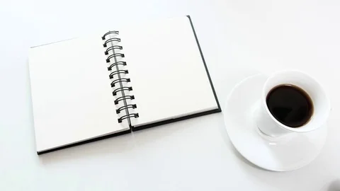 Human hand puts a notebook, a pad and a cup of coffee Video stock 74359605