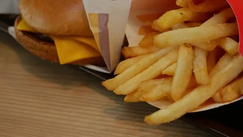 Human hand reaching to grab crispy french fries Stock Footage 323295049