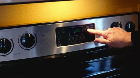 Human hand regulating cooking on oven. Woman setting temperature. Stock Footage 153780358