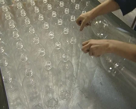 Human hand reloading plastic PET bottle in factory Stock Footage 10701382