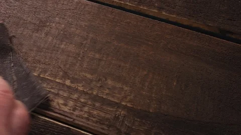 A human hand rubs painted boards with sandpaper Stock Footage 274453383