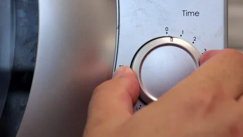The Human Hand Sets The Microwave Oven's Operating Time By Two Minutes Video stock 261892200