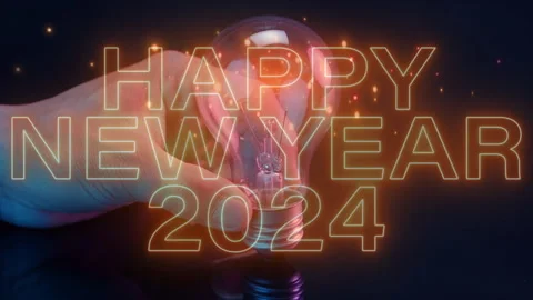 Human hand showing light bulb with virtual word of happy new year 2024. Stock Footage 252345838