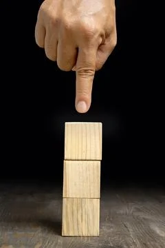 A human hand shows a stack of wooden cubes 스톡 사진
