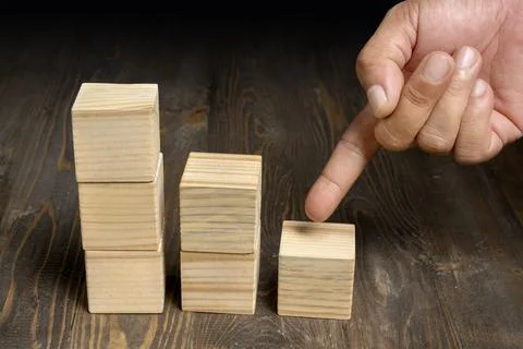 A human hand shows a stack of wooden cubes 스톡 사진
