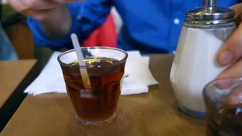 Human hand stirring Turkish tea Stock Footage 75902685