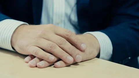 Human hand in a suit on the table Stock Footage 71216512