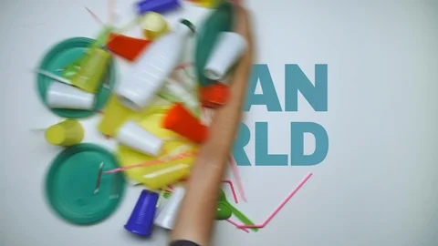 Human hand sweep away plastic disposable cups, straws cutlery, cotton bud sticks Stock Footage 97541988
