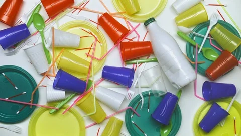 Human hand sweep away plastic disposable cups, straws cutlery, cotton bud sticks 스톡 동영상 97542238