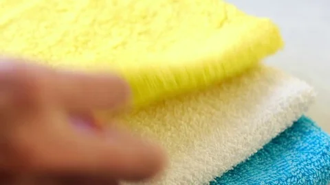 Human hand takes apiece of soap and an yellow towel Stock Footage 74227637