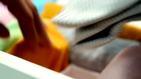 Human hand takes clothes from the chest of drawers Stock Footage 79708462