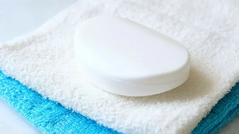 Human hand takes a piece of soap and a white towel Stock Footage 74227638