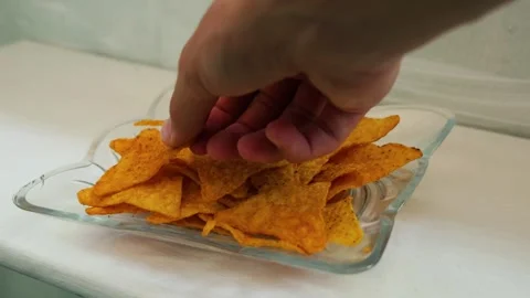 Human hand taking crunchy tortilla chips Stock Footage 341859091