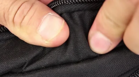 Human hand testing black and red synthetic material of bag, outside and inside Video stock 50970459