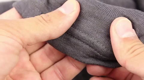 Human hand testing gray synthetic thermal underwear, closeup(macro) Video stock 50962157