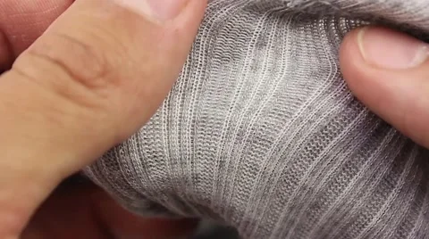 Human hand testing gray wool thermal underwear, closeup(macro) Video stock 50962159