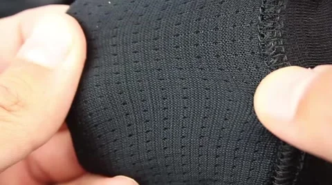 Human hand testing synthetic thermal underwear,  outer side and wrong side Video stock 50961838