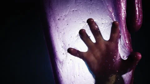Human hand through translucent sticky nastiness - scene of a noon nightmare Stock Footage 141924583