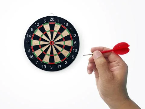 Human hand is throwing the darts target to the darts board. a man's hand thro Stock Photos