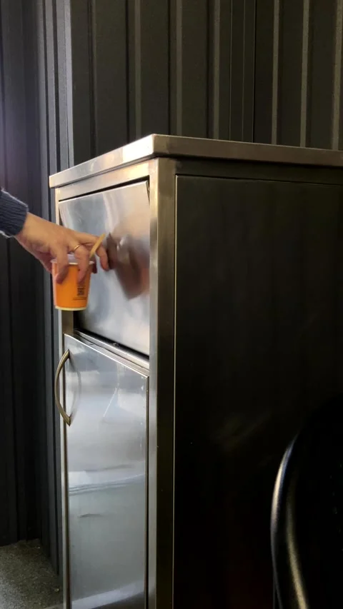 Human hand throwing disposable coffee cup into trash can close up Stock Footage 339179739