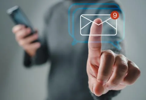 Human hand touching email on virtual screen. New email notification concept.. Stock Photos