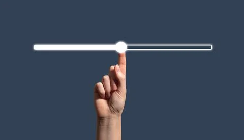 Human hand touching a glowing progress bar or slider on a dark background. Stock Photos