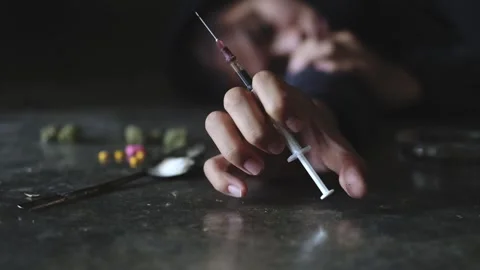 Human hand trying to reach,  on  concrete floor. Drugs addiction and withdr.. 스톡 동영상 336936145