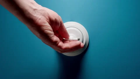 Human Hand Turning On A Toggle Switch On Blue Wall Vídeos de archivo 146678250