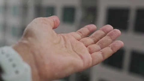 Human Hand Under Heavy Rain, Female Hand Catches Rain Drops while Standing in a Stock Footage 278299283