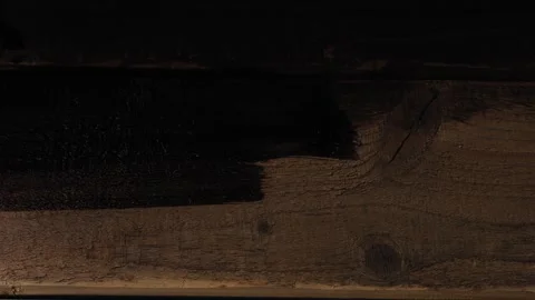 A human hand uses a brush to cover the boards with dark brown paint. Medium.. Stock Footage 276505212