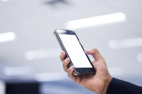 Human Hand using smartphone mobile phone with social media concept. Stock Photos