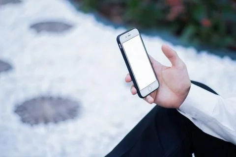 Human Hand using smartphone mobile phone with social media concept. Stock Photos