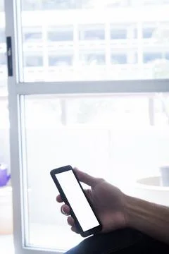 Human Hand using smartphone mobile phone with social media concept. Stock Photos