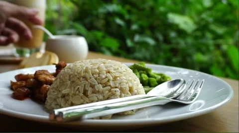 Human hand using spoon eating brown rice Stock Footage 52683426