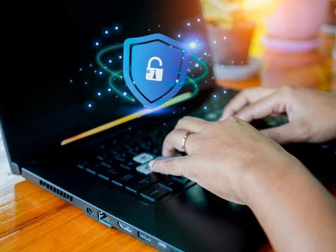 Human hand working on computer and protection icon. Represents the code pro.. Foto stock