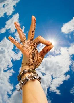 Human hands on a background sky and sun. Stock Photos