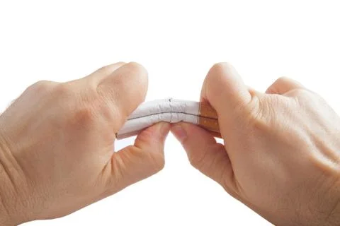 Human hands breaking stack of cigarettes Foto stock
