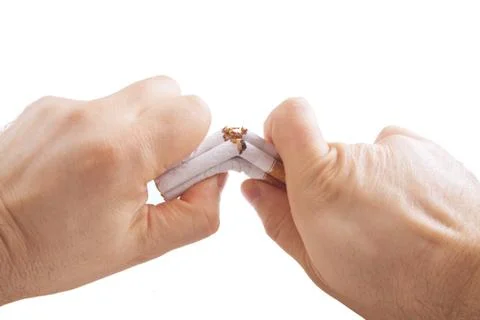 Human hands breaking stack of cigarettes Stock Photos