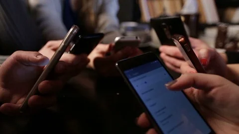 Human hands circle using smart phones in cafe Stock Footage 72533369