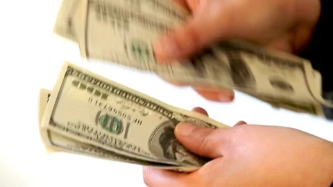 Human hands converting hundred dollar bills manually at white background, Stock-Footage 336261185