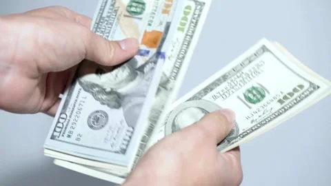 Human hands converting hundred dollar bills manually at white background, Video stock 336261280