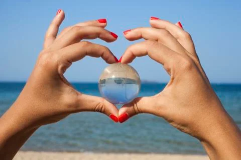 Human hands with crystal globe Stock Photos