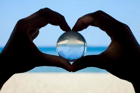 Human hands with crystal globe Stock Photos