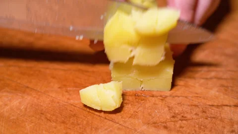 Human hands cut boiled potatoes into slices. Stock Footage 249284975