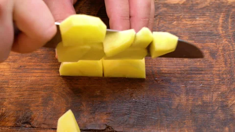 Human hands cut raw potatoes into slices. Stock Footage 251648805